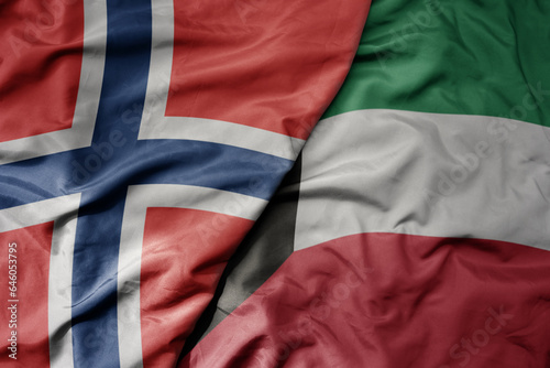 big waving national colorful flag of norway and national flag of kuwait .