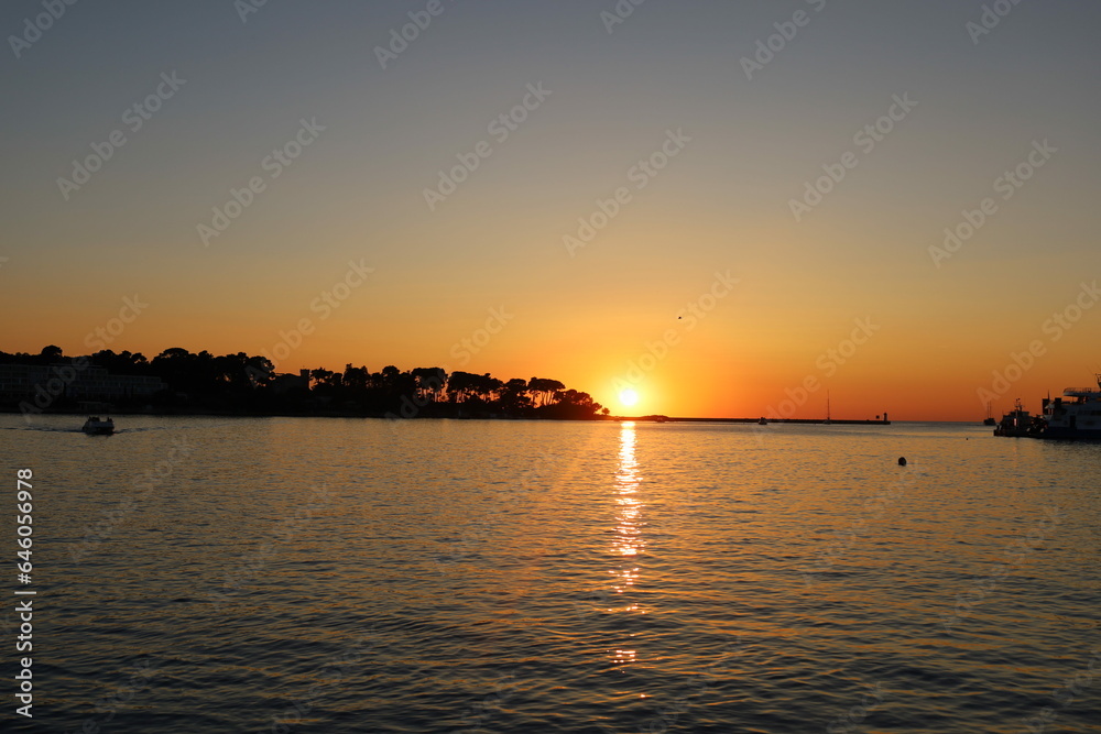 Sunset on the Adriatic sea in Porec, Istria, Croatia, Europe. Beautiful sunset by the Adria sea, The sun is setting over the sea, Porec Sunset on the Adriatic sea in Porec, Istria, Croatia, Europe. Beautiful sunset by the Adria sea, The sun is setting over the sea, Porec