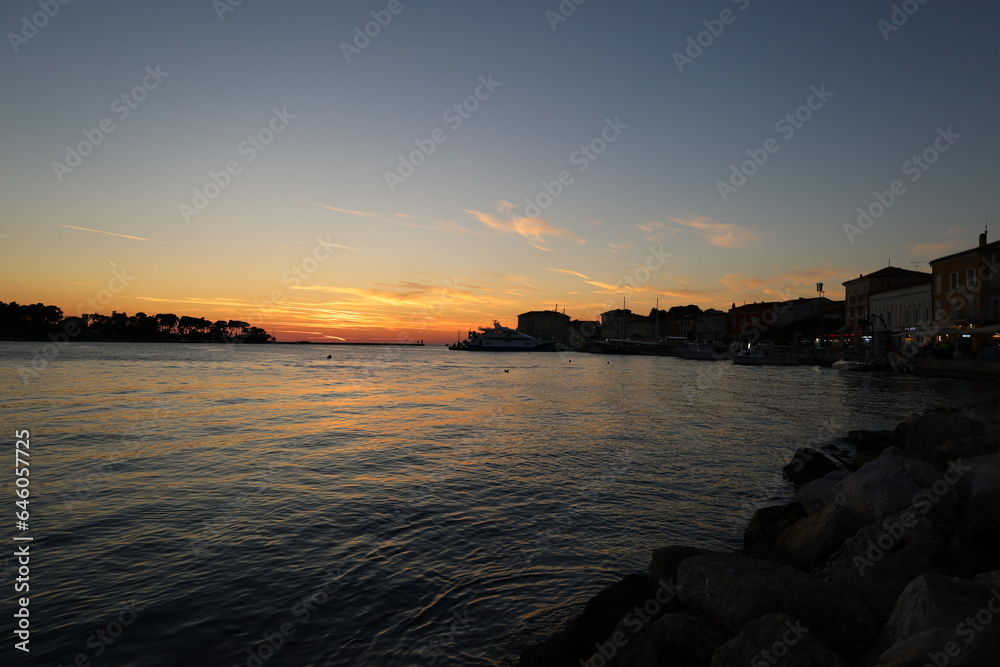 Sunset on the Adriatic sea in Porec, Istria, Croatia, Europe. Beautiful sunset by the Adria sea, The sun is setting over the sea, Porec