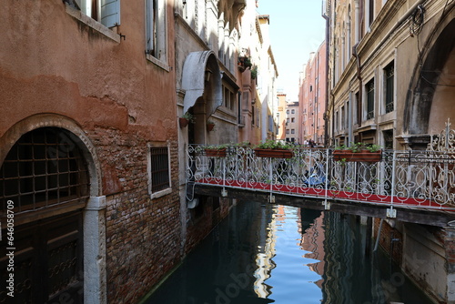 Canal in Venice, Italy, Europe. Architecture and landmark of Venice. Narrow canal with boat and bridge in Venice, Italy.  © Inha