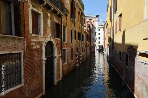 Canal in Venice, Italy, Europe. Architecture and landmark of Venice. Narrow canal with boat and bridge in Venice, Italy. 