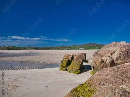 A view across the deserted Ardroil Sands (Uig Sands) on the Isle of Lewis in the Outer Hebrides, Scotland, UK. Taken with a clear blue sky on a sunny day in summer.