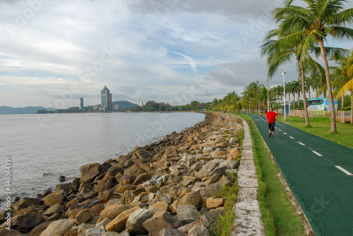 An embankment of Kota Kinabalu with a view of Kinabalu Tower, also known as Sabah State Administrative Center, Sabah, Malaysia