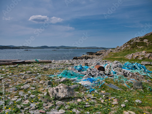 Lost plastic fishing nets and ropes washed up on a remote beach on the island of Bernera (Great Bernera) off the coast of north west Lewis in the Outer Hebrides, Scotland, UK. photo