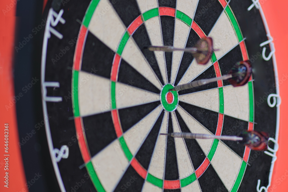 Darts arrows hitting the center of dartboard, Business success concept Darts arrows hitting the center of dartboard, Business success concept