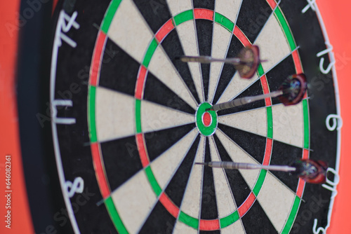 Darts arrows hitting the center of dartboard, Business success concept