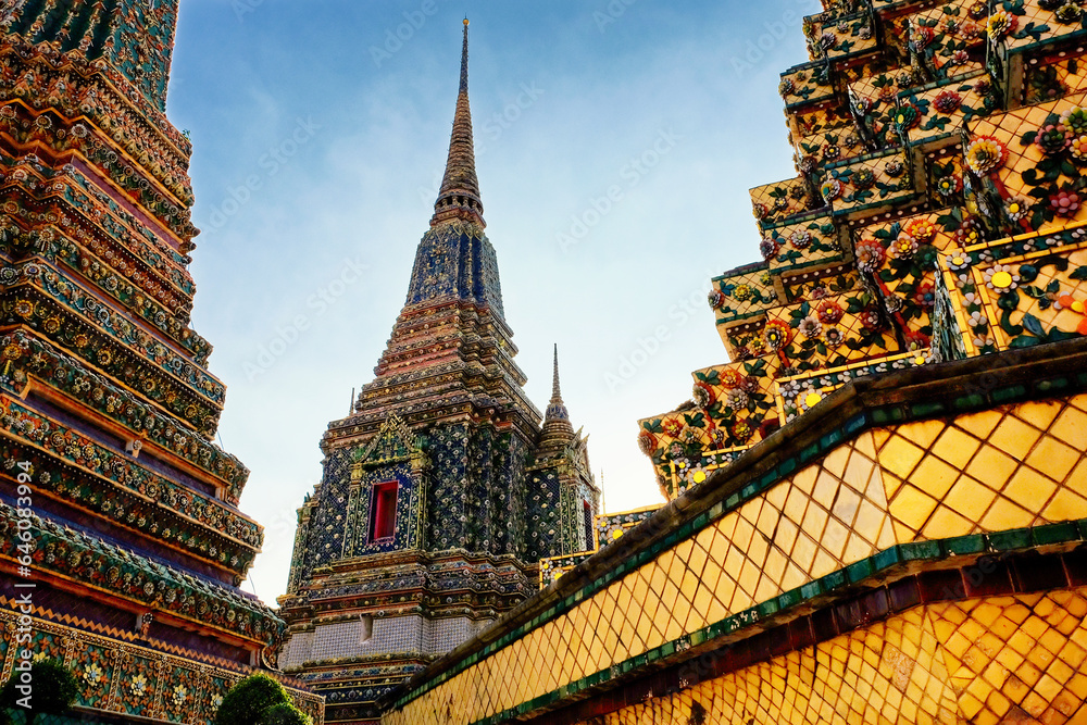 Gorgeous wall embellishments portraying the exterior of Wat Pho temple's Buddhist stupas in Thailand.