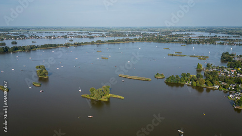 aerial footage drone shot of Elfhoeven lake in Reeuwijkse Plassen Netherlands. Dutch recreational wetland area is popular with many boats on hot sunny summer day