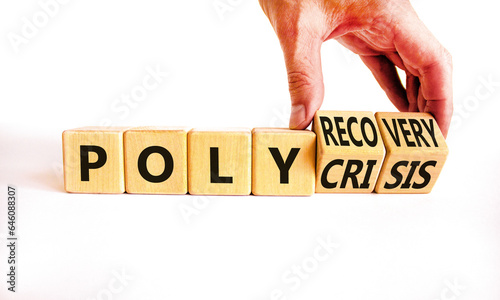 Polycrisis or polyrecovery symbol. Concept words Polycrisis Polyrecovery on wooden cubes. Beautiful white background. Businessman hand. Business Polycrisis or polyrecovery concept. Copy space. photo