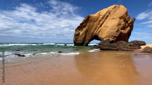 Stone rock at ocean side beach in a summer day. Santa Cruz beach, Torres Vedras, Portugal
