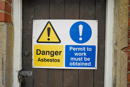 Sign warning of dangers of working with asbestos, permit work required