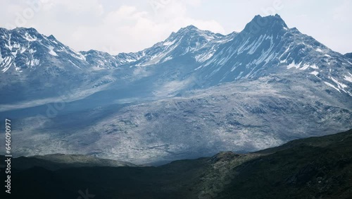 Aerial Over Valley With Snow Capped Mountains In Distance photo