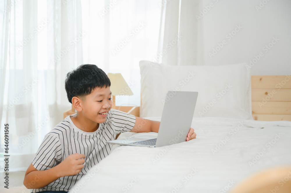 Asian male schoolboy use laptop computer study online at home happy students with education typing on keyboard looking at pc screen Watch Webinars Online Courses Do Homework Asian male schoolboy use laptop computer study online at home happy students with education typing on keyboard looking at pc screen Watch Webinars Online Courses Do Homework