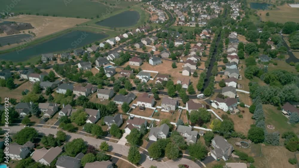 Above aerial view of trees and residential houses and yards near city . Above aerial view of trees and residential houses and yards near city .