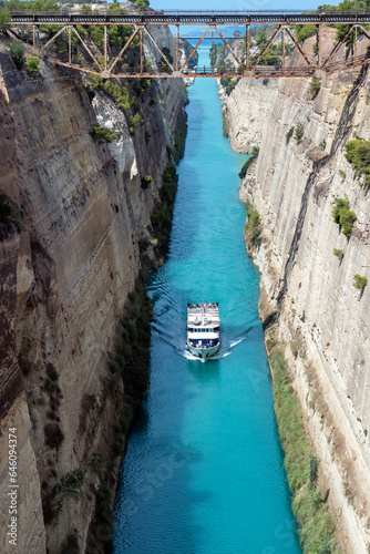 Tourist ship crosses the Corinth canal, the canal that separates Peloponnese from continental Greece, Europe.