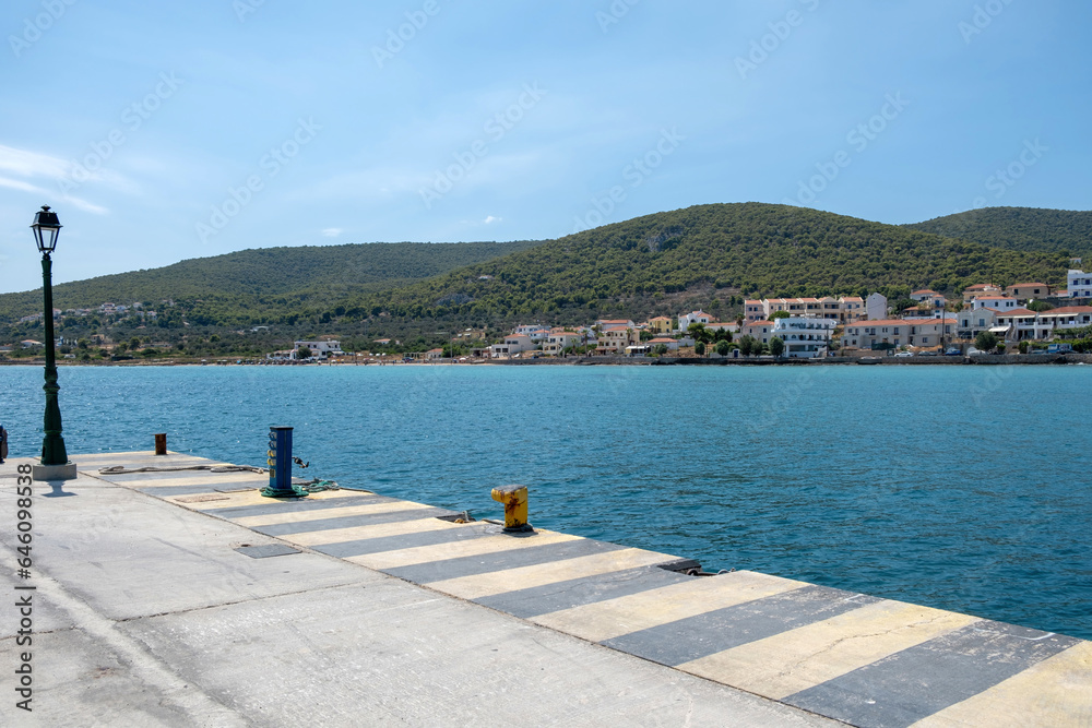 Obraz premium Greece, Megalochori, Milos, Miloi port, Agistri island. Harbor with bollard, calm sea, blue sky.