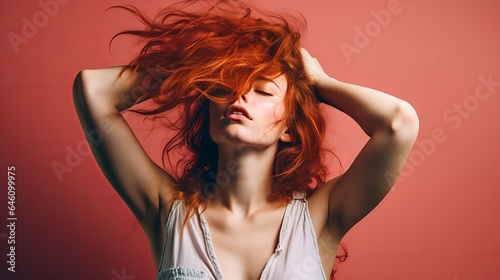 An image of a young woman with her hand in her hair