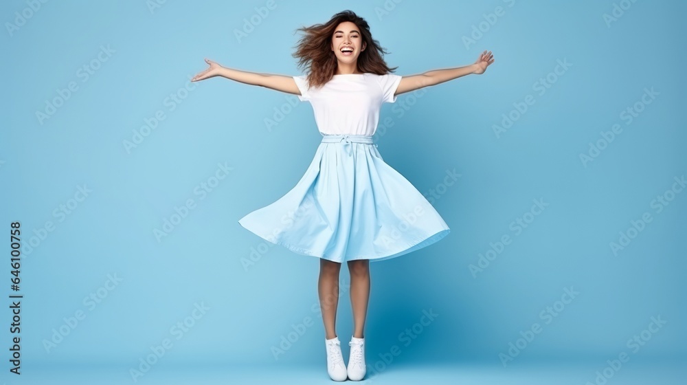 Full length body size view of attractive, happy girl posing over bright blue background with copy space. Full length body size view of attractive, happy girl posing over bright blue background with copy space.
