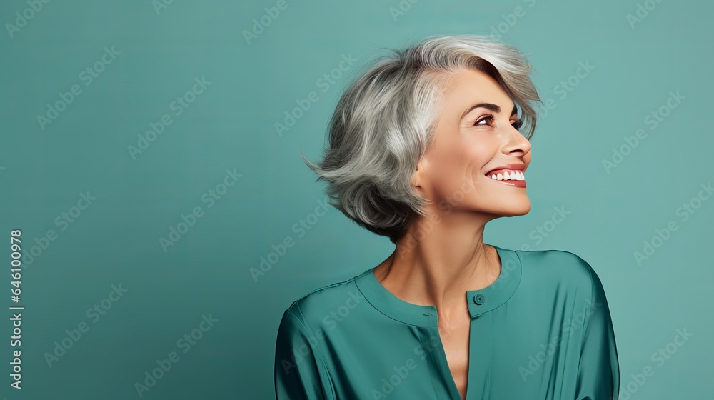 Picture of a mature, happy, pretty woman having fun in a club, taken from the side, isolated on a turquoise background. Picture of a mature, happy, pretty woman having fun in a club, taken from the side, isolated on a turquoise background.