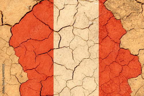 Drought. On dry, cracked ground, the image of the flag of Peru.