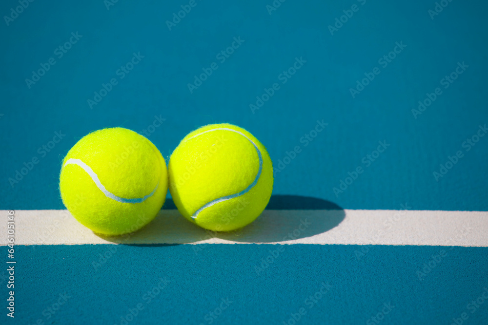 Tennis ball on the blue-coated court	