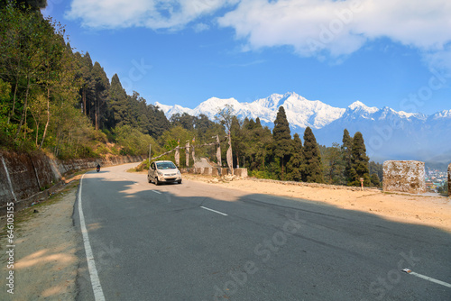 Scenic mountain road near Lava Kalimpong, India, with the Kachenjunga Himalaya range in the background photo