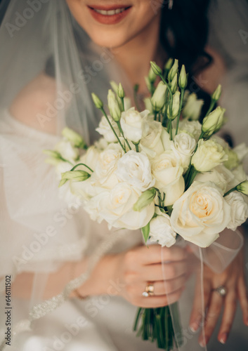 Bridal Elegance  Holding a Bouquet of White Roses on Her Wedding Day         . Radiant bride clutching a bouquet of white roses  a symbol of purity and love  on her wedding day.