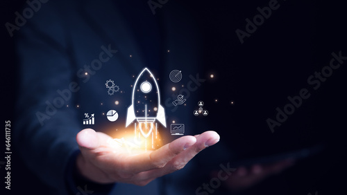 Businessman holding icons about business and investment, Rocketing take off with a targeted launch speed, Wealth fast, Graph depicting rising earning, increasing profits exemplifies financial success, photo