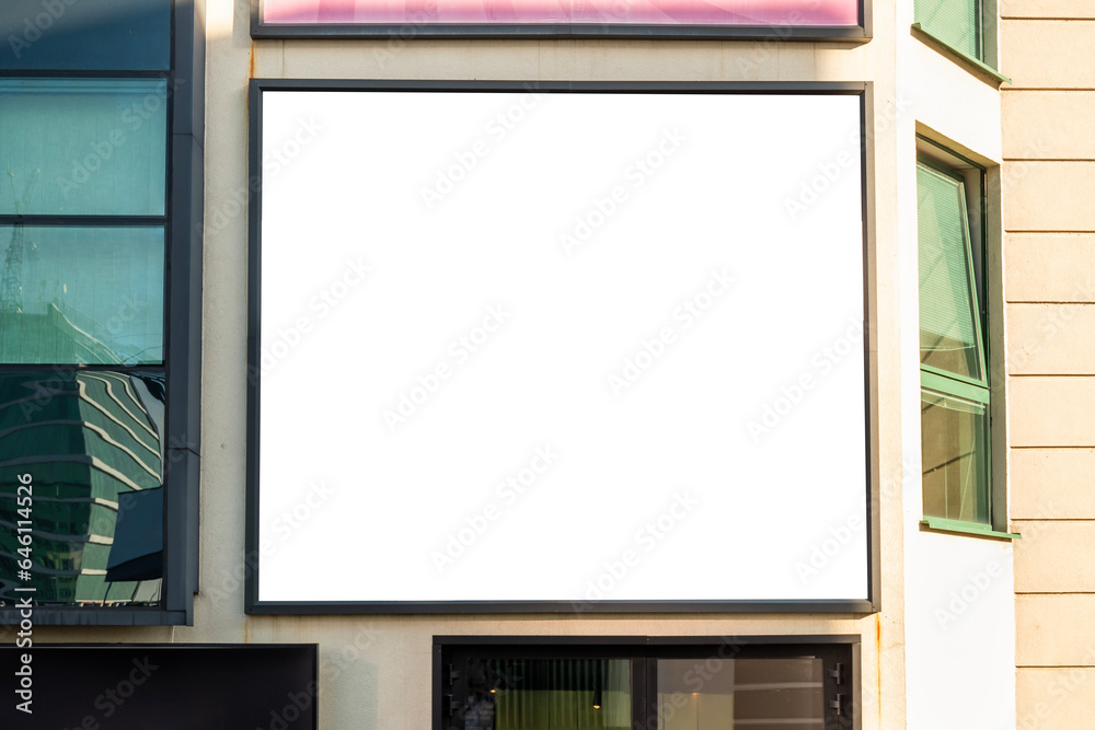 Blank white advertising banner on the wall of the modern building Blank white advertising banner on the wall of the modern building