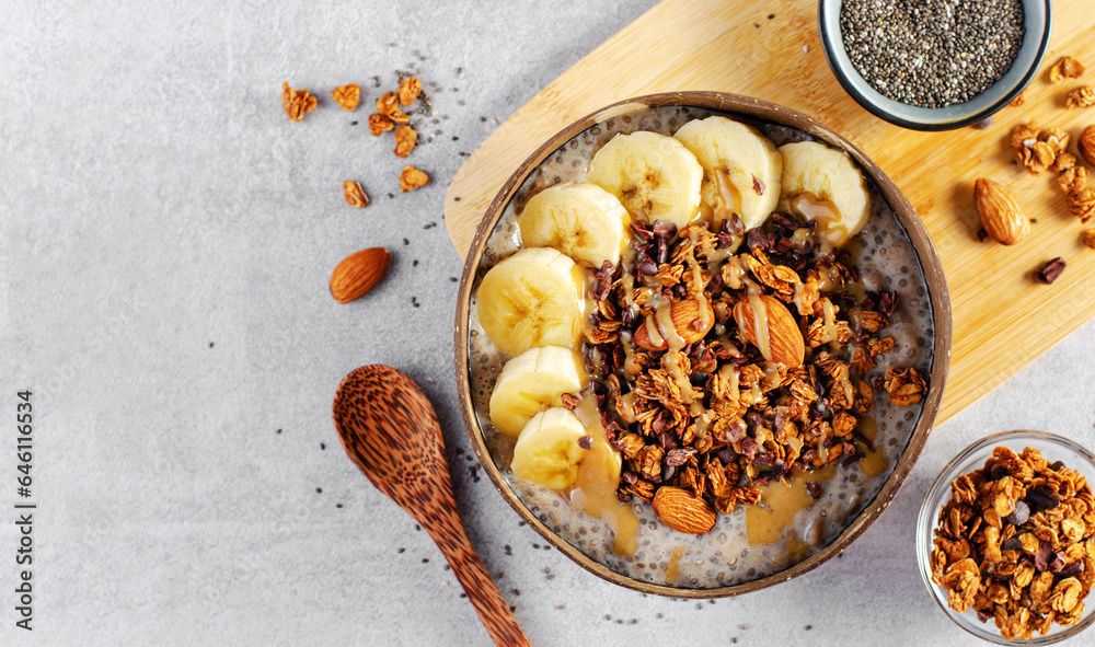 Fototapeta premium Chia Pudding Bowl with Banana, Granola and Cinnamon, Healthy Breakfast, Vegetarian Food