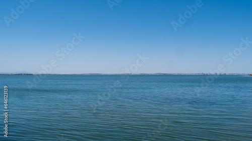 View of the Mediterranean coast from a boat, clean blue sky, outdoor life.