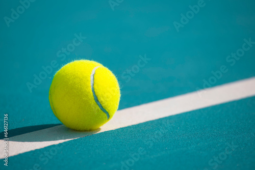 Tennis ball on the blue-coated court © Павел Мещеряков