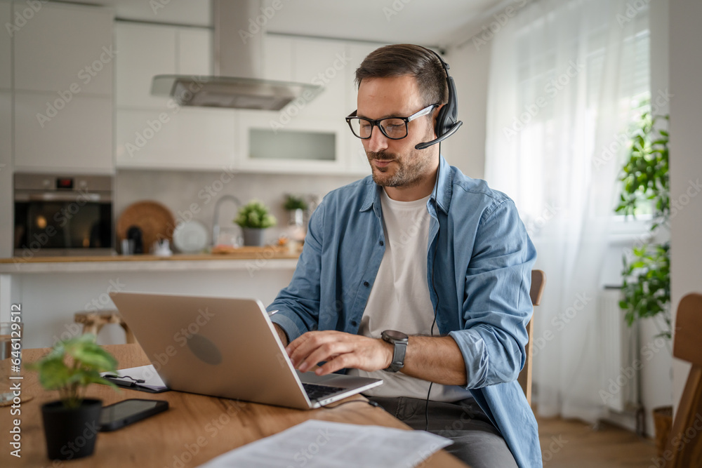 One man caucasian male freelancer work from home on laptop computer One man caucasian male freelancer work from home on laptop computer