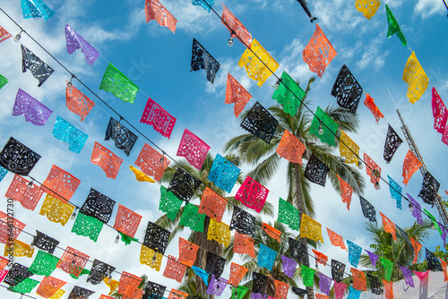 Mexican papel picado in the streets of the magical town of Todos Santos in La Paz Baja California Sur. Mexico, under a sunny summer afternoon.