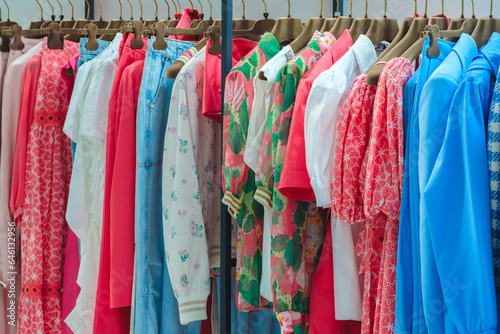 Fashion clothes on clothing rack  Closeup of rainbow color choice female wear on hangers in store closet  Summer home wardrobe. © Aleksandr Matveev