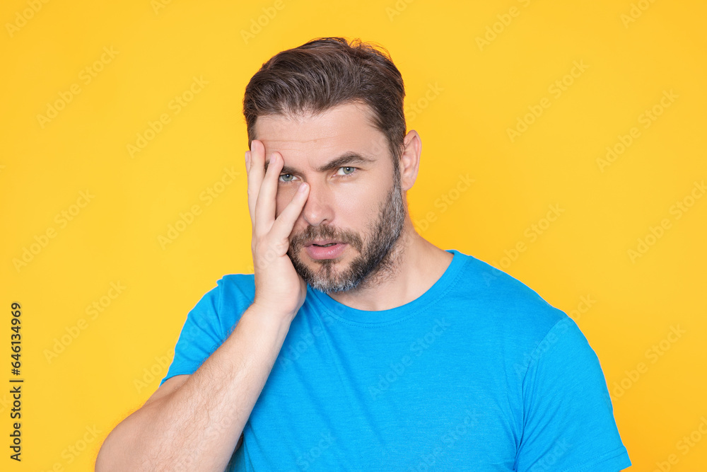 Thougthful thinking man looks pensively aside makes plannings isolated over yellow background. Handsome thinking man considers. Portrait of pensive thinking man. Thoughtful guy thinking decision.