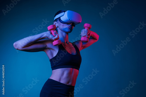 athletic girl doing sports online in VR glasses on a dark background, online sports training