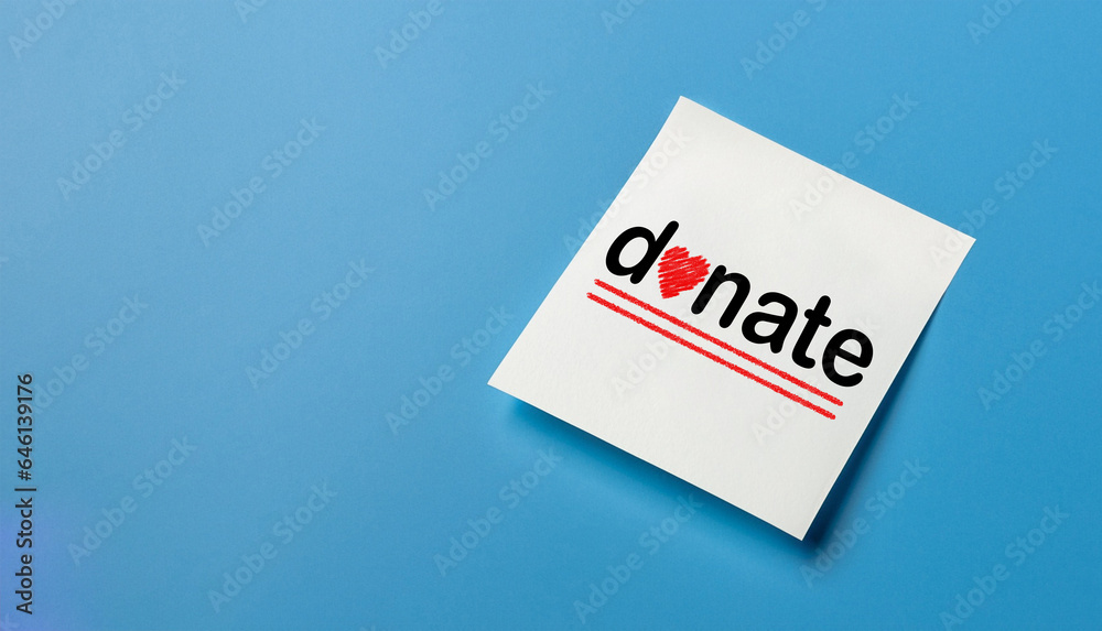 Note paper with donation concept on blue background Note paper with donation concept on blue background