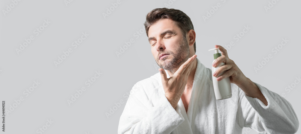 Banner of man with bottle of cosmetic products. Beauty man hold cosmetic bottle. Cosmetics cream for skincare. Spa beauty products. Man advertising bottle with dispenser for liquid soap, gel or foam. Banner of man with bottle of cosmetic products. Beauty man hold cosmetic bottle. Cosmetics cream for skincare. Spa beauty products. Man advertising bottle with dispenser for liquid soap, gel or foam.