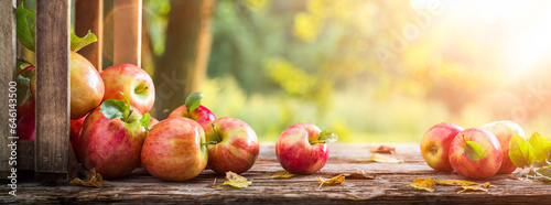 Close-up Of Apples And Wooden Crate On Table - Autumn And Harvest Concept