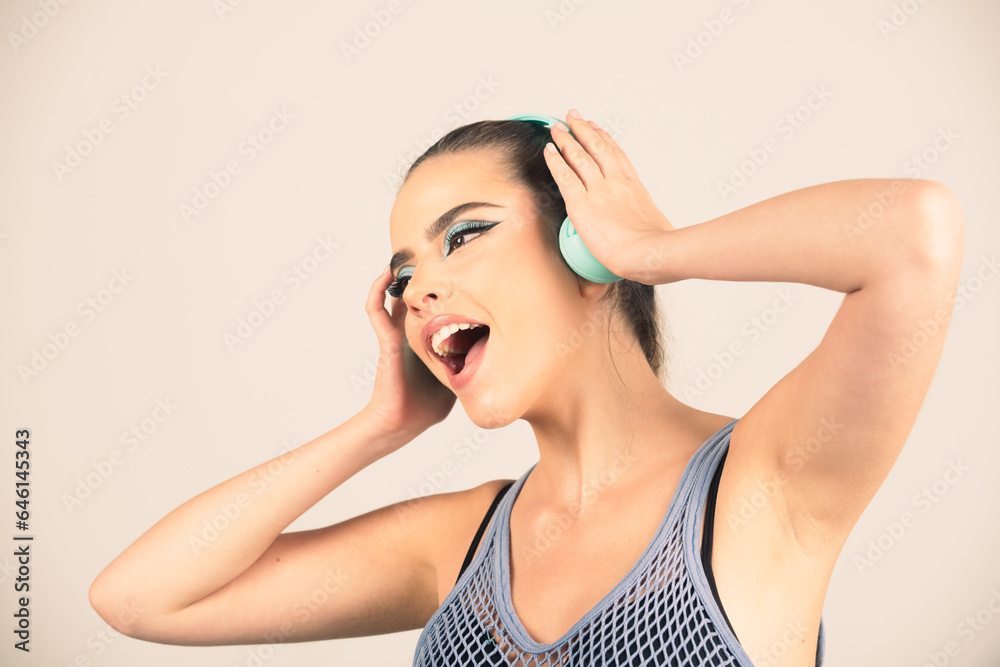 Excited girl dancing and singing. Sensual young woman listening music with headphones. Excited girl dancing and singing. Sensual young woman listening music with headphones.