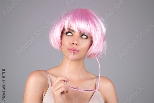 Funny girl with pink wig. Beauty skin. Woman beauty face, clean fresh skin natural makeup, beauty eyes and lips of female photo model.