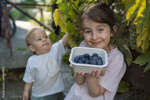 Close up of children with blueberries 
