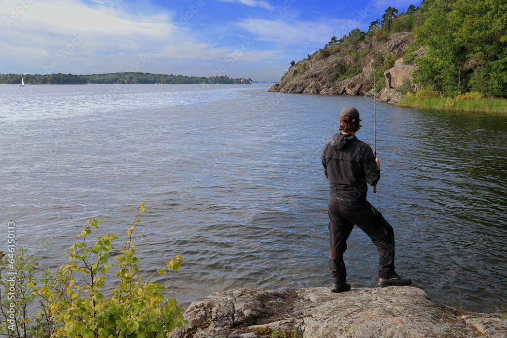One man fishing at a Swedish lake called Mälaren. September 2023. One man fishing at a Swedish lake called Mälaren. September 2023.