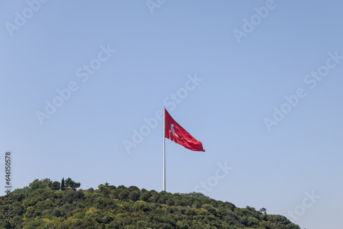 Istanbul, Turkey - July 22,2023: The flag of Turkey flying against a blue sky in Istanbul 