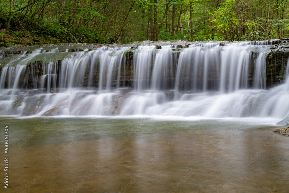 Fototapeta premium Late afternoon Summer photo of a waterfall in Robert H. Treman State Park near Ithaca NY, Tompkins County New York. 