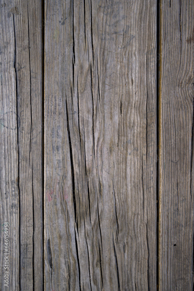 Old light-toned wood with vertical cracks for background or text Old light-toned wood with vertical cracks for background or text