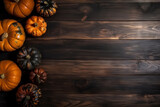 Autumn side border of pumpkins top view on dark wooden background. Flat lay composition with copy space. Concept of Thanksgiving day or Halloween.
