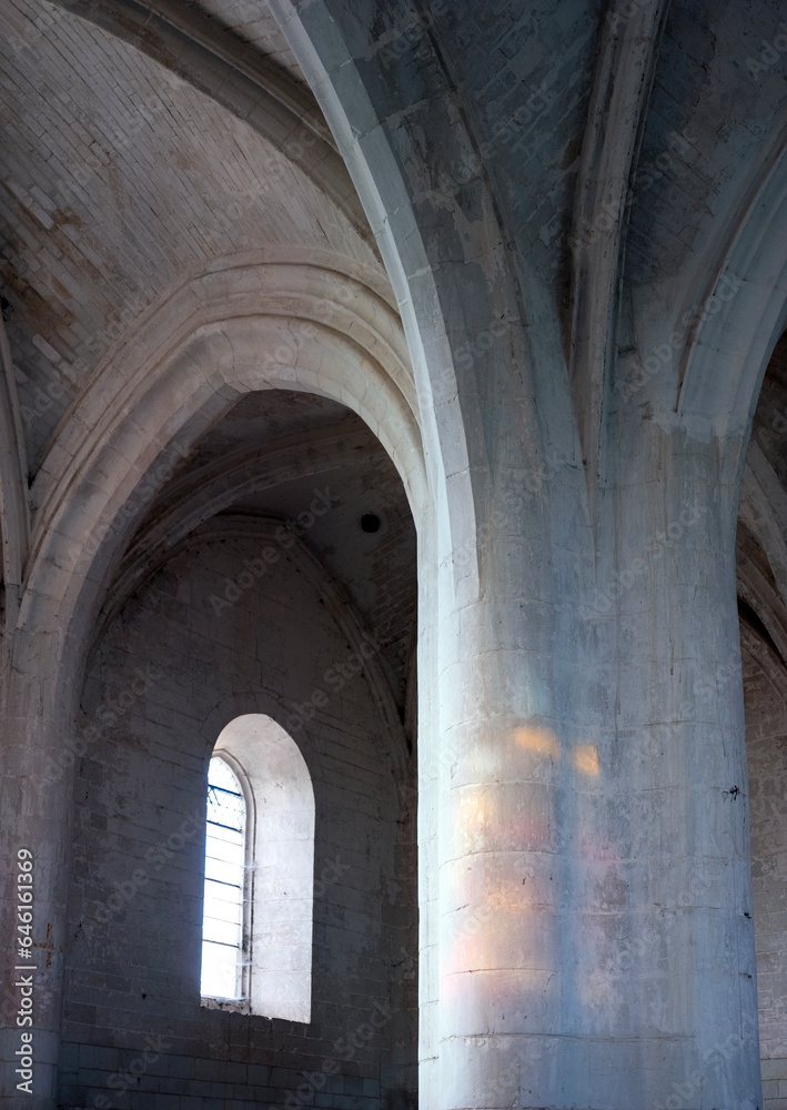 pillar in old french church with arched ceilings above