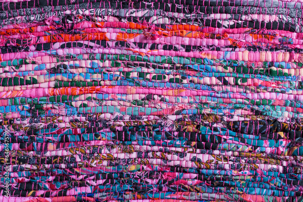 background of handmade fabric sewn with ethnic multicolor threads in Viva Magenta tone horizontally